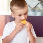 little boy eating nuggets